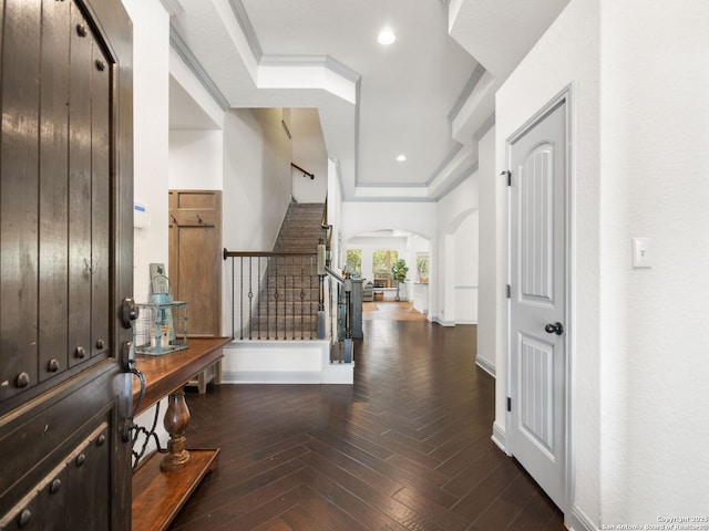 entrance foyer featuring arched walkways, recessed lighting, parquet flooring, baseboards, and stairway