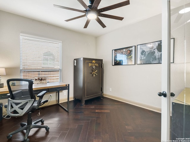 office area featuring baseboards and ceiling fan