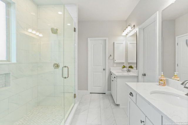 bathroom featuring a stall shower, two vanities, and a sink