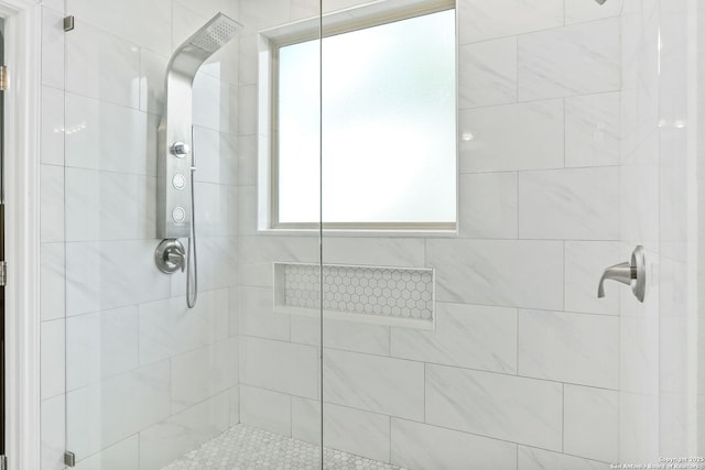 bathroom with a tile shower