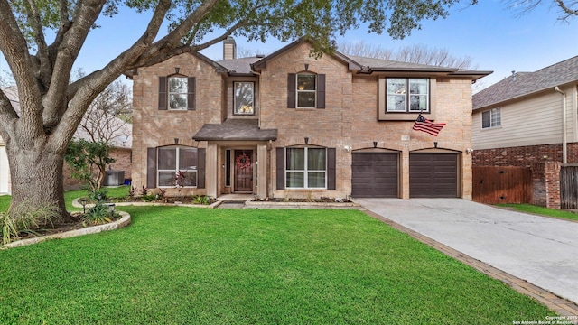 traditional-style home with brick siding, fence, driveway, a chimney, and a front yard