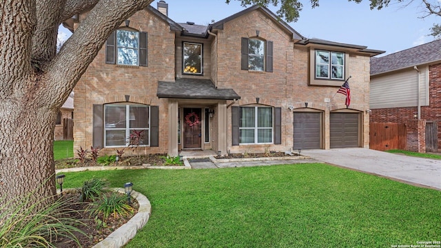 view of front of house featuring a garage, brick siding, fence, driveway, and a front lawn