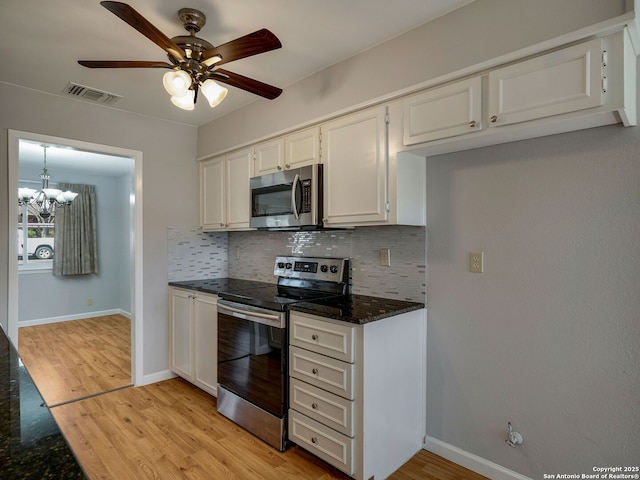 kitchen with stainless steel appliances, tasteful backsplash, visible vents, and white cabinetry