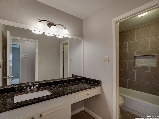 bathroom featuring toilet, tile patterned flooring, baseboards, and vanity