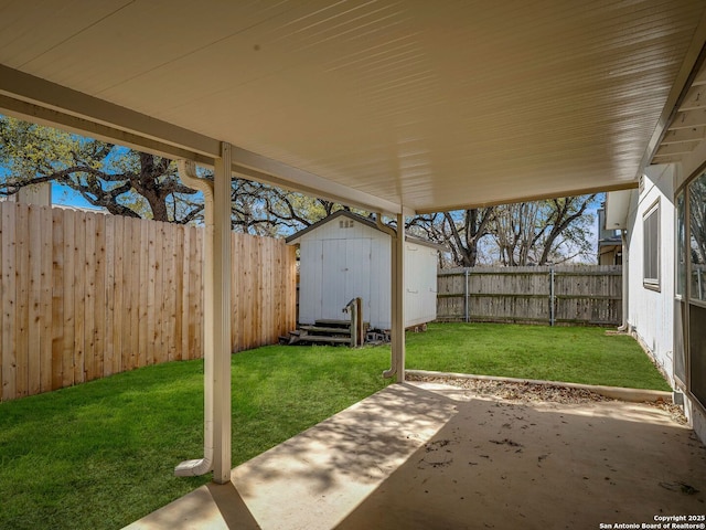 view of patio featuring an outbuilding, a shed, and a fenced backyard