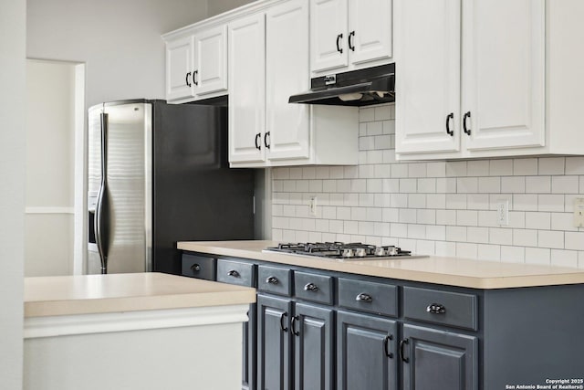 kitchen with white cabinets, under cabinet range hood, stainless steel appliances, and light countertops