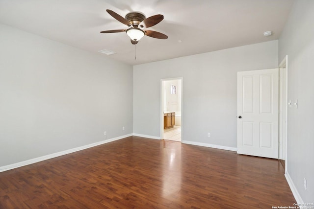 unfurnished bedroom featuring ceiling fan, wood finished floors, connected bathroom, and baseboards