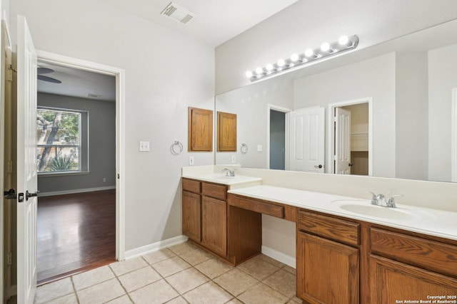 full bath with double vanity, a sink, visible vents, and tile patterned floors