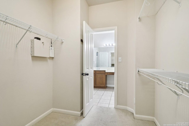 spacious closet with light carpet