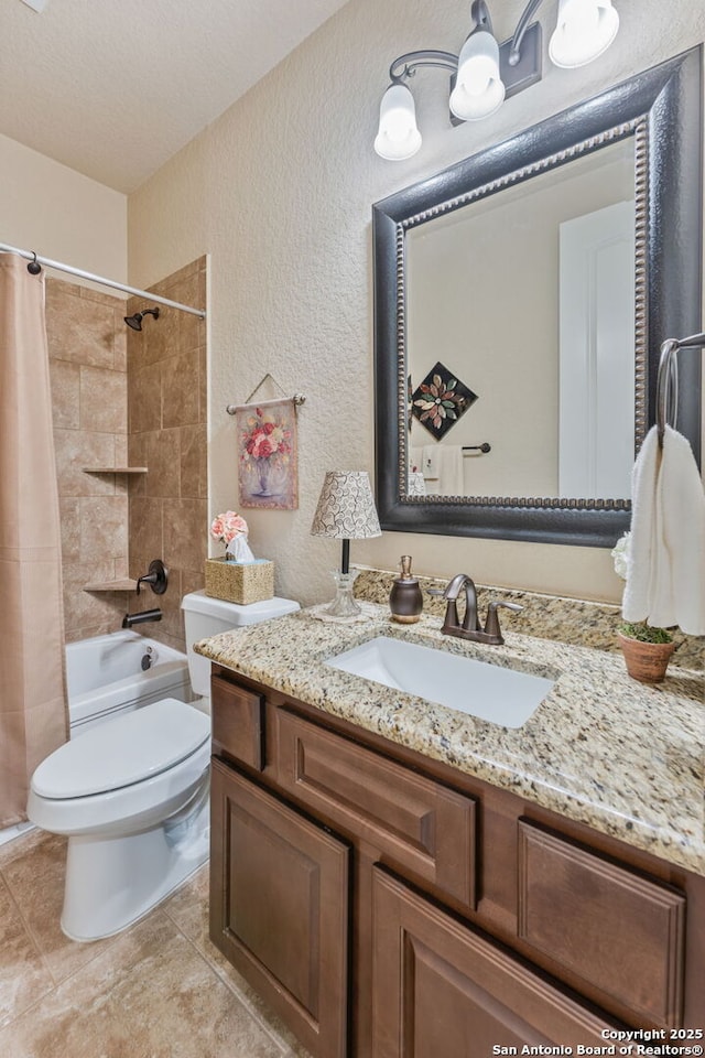 bathroom with a textured wall, toilet, tile patterned floors, a textured ceiling, and vanity