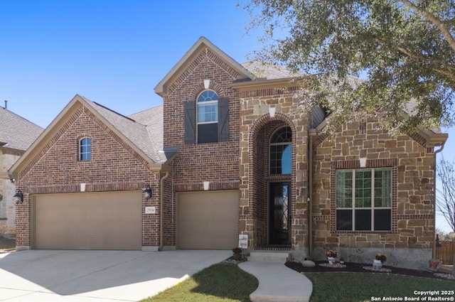 traditional-style home with stone siding, concrete driveway, and brick siding