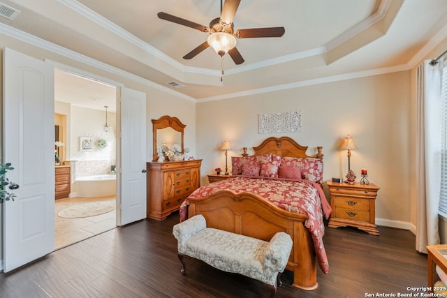 bedroom featuring a raised ceiling, visible vents, and dark wood-style flooring