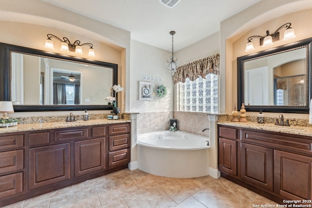 bathroom with two vanities, a shower with shower door, a garden tub, and a sink