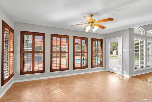 interior space featuring a healthy amount of sunlight and ceiling fan