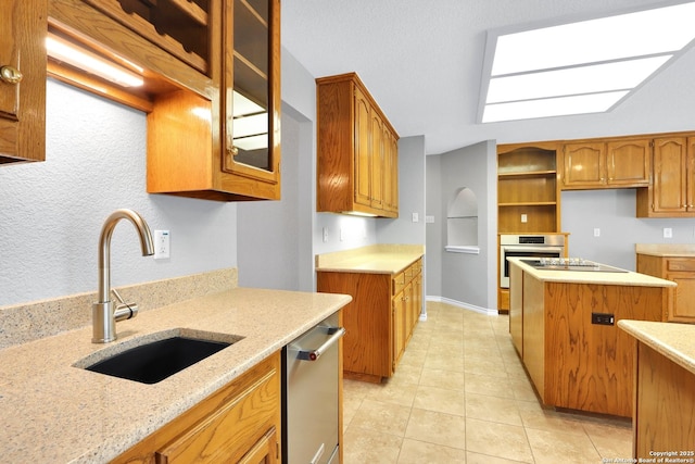 kitchen with light tile patterned floors, brown cabinetry, a sink, and oven