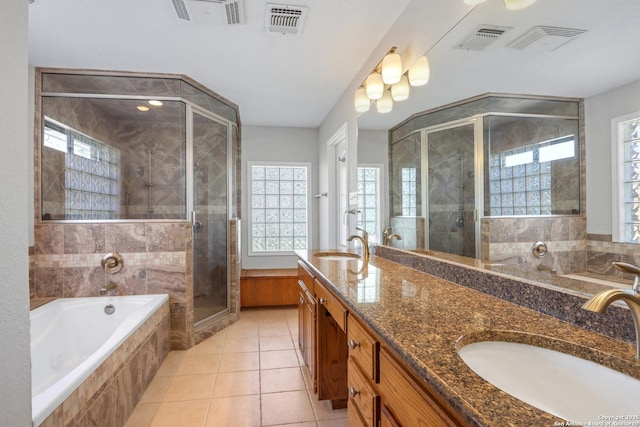 full bath with a bath, a shower stall, double vanity, and a sink