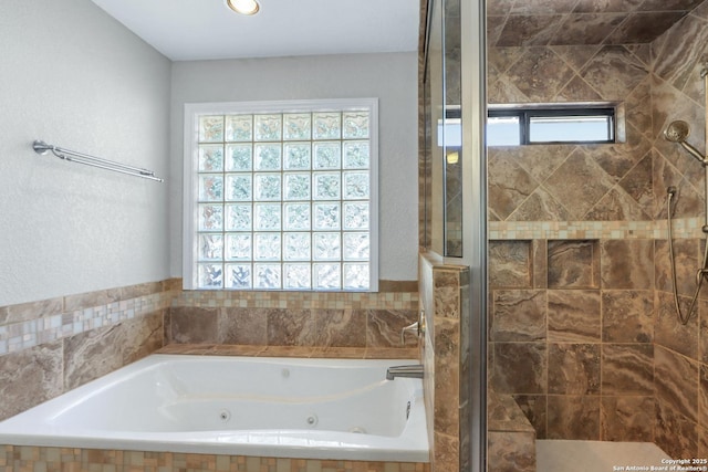 full bathroom with a whirlpool tub, a shower stall, and a wealth of natural light