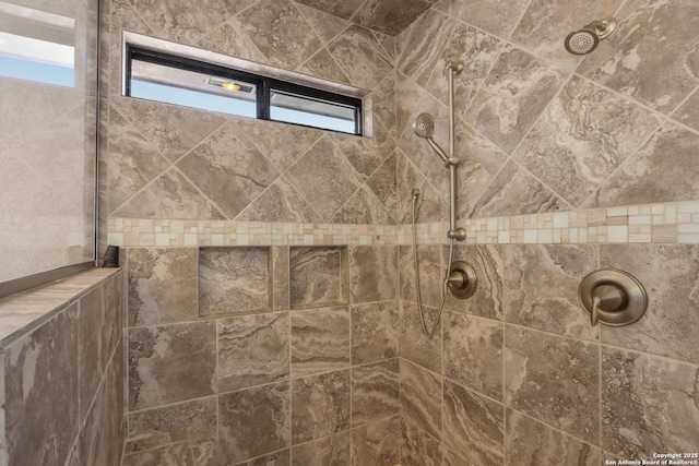 interior details featuring tiled shower