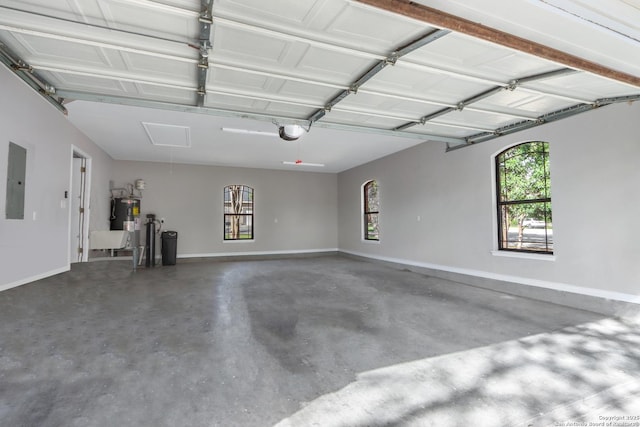 garage featuring baseboards, electric panel, electric water heater, and a garage door opener