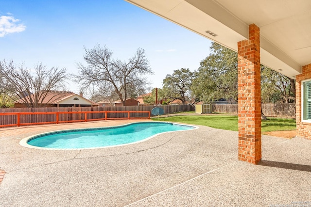 view of pool with a patio, an outdoor structure, a fenced backyard, and a fenced in pool