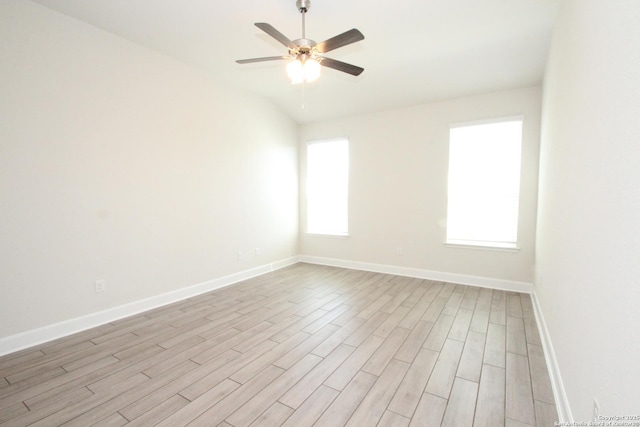 unfurnished room with ceiling fan, baseboards, lofted ceiling, and light wood-style floors