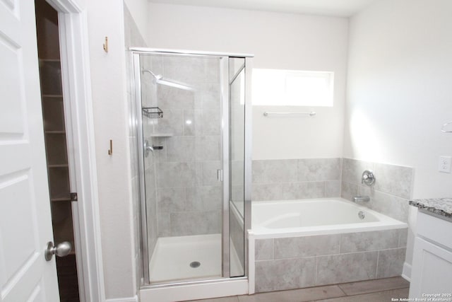 full bath with a shower stall, a bath, and vanity