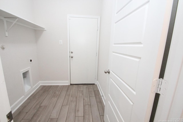 laundry room featuring laundry area, baseboards, electric dryer hookup, and light wood-style floors