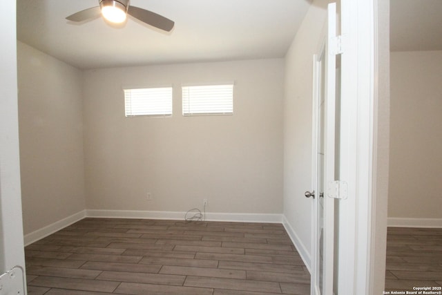 empty room with a ceiling fan, baseboards, and wood finished floors