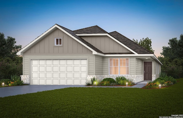 view of front of house with a lawn, concrete driveway, roof with shingles, an attached garage, and board and batten siding