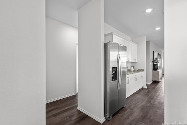 kitchen featuring dark wood-style flooring, recessed lighting, stainless steel fridge with ice dispenser, white cabinets, and baseboards