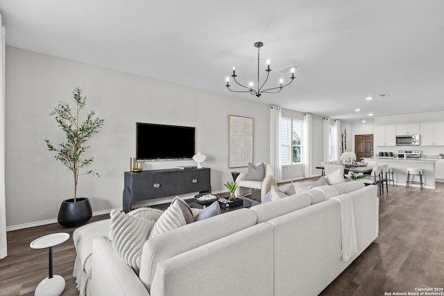 living room featuring baseboards, visible vents, dark wood finished floors, a chandelier, and recessed lighting