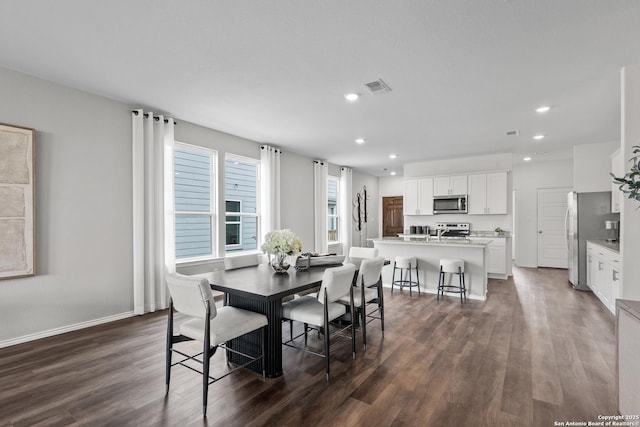 dining area with baseboards, visible vents, dark wood-style flooring, and recessed lighting