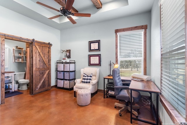 office featuring ceiling fan, a barn door, and concrete floors