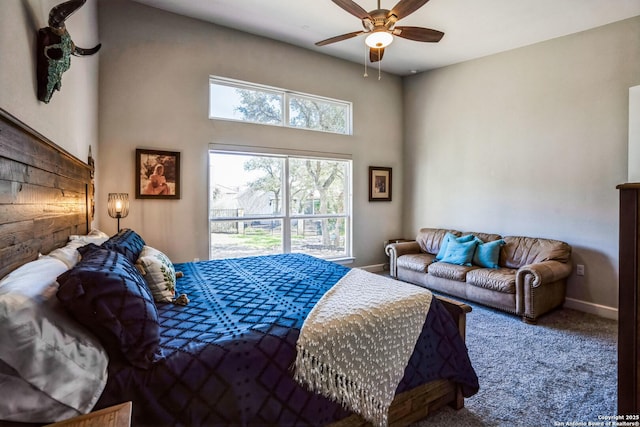 carpeted bedroom featuring ceiling fan and baseboards