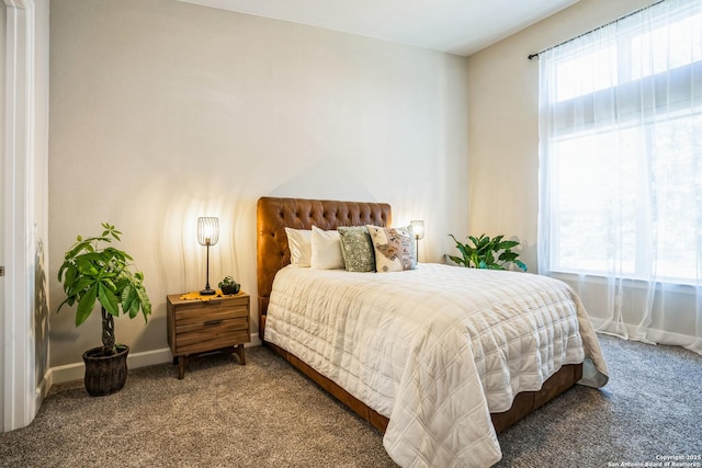 bedroom with carpet and baseboards