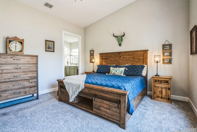 bedroom with carpet, lofted ceiling, visible vents, connected bathroom, and baseboards