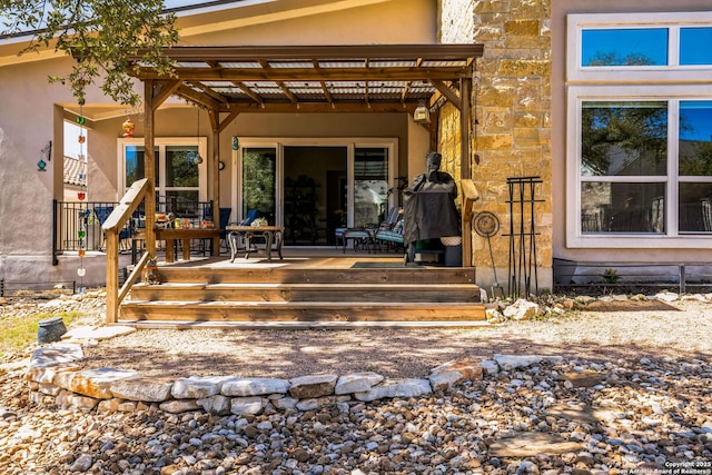 entrance to property with stucco siding