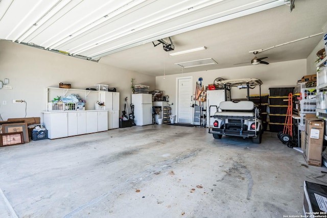 garage with freestanding refrigerator and a garage door opener