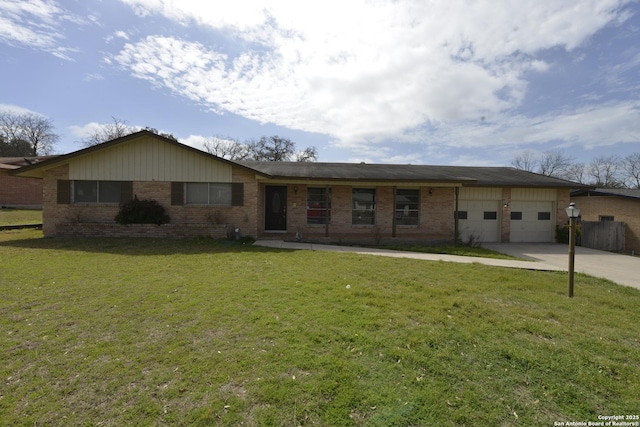 ranch-style house featuring a front lawn, brick siding, driveway, and an attached garage