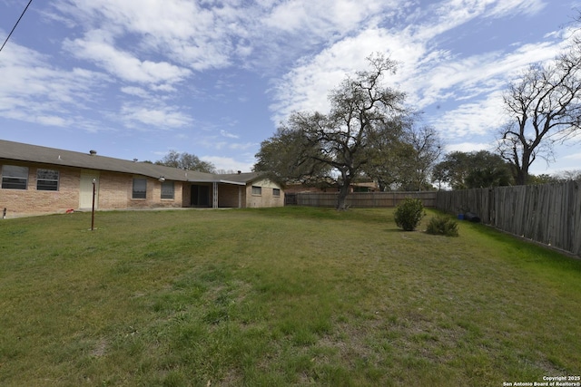 view of yard with a fenced backyard