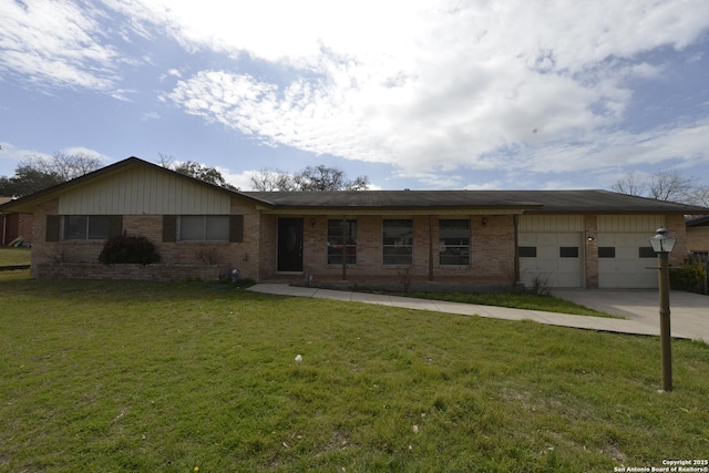 ranch-style home featuring concrete driveway, brick siding, an attached garage, and a front yard