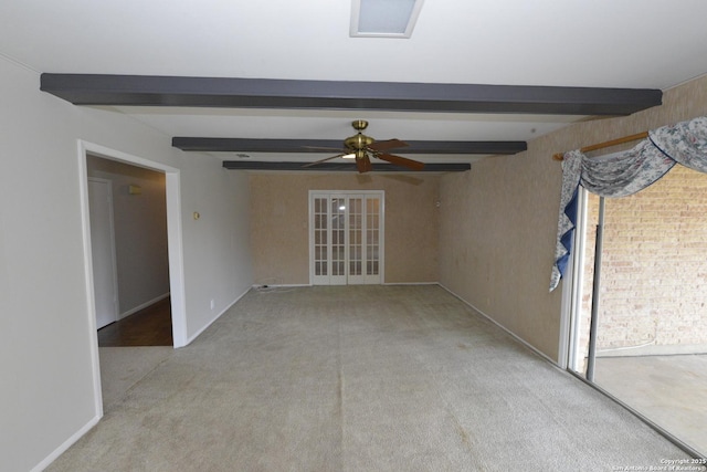 empty room featuring light carpet, beamed ceiling, and a ceiling fan