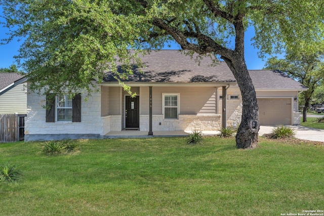 ranch-style house featuring stone siding, a front yard, and driveway