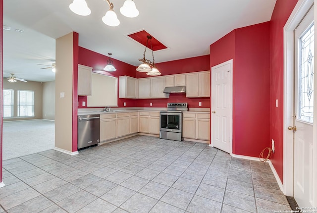 kitchen with under cabinet range hood, appliances with stainless steel finishes, and a wealth of natural light