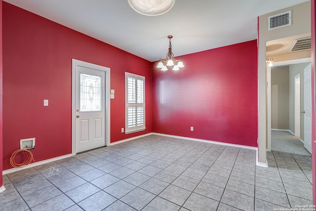 spare room featuring an inviting chandelier, baseboards, light tile patterned floors, and visible vents