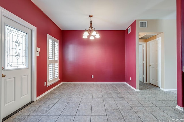 interior space featuring an inviting chandelier, baseboards, visible vents, and light tile patterned flooring