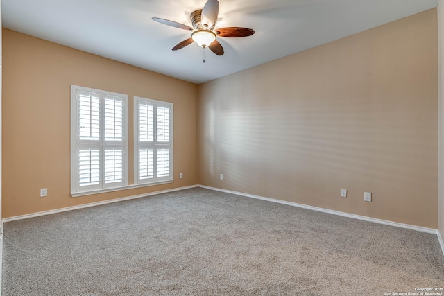 carpeted empty room featuring a ceiling fan and baseboards