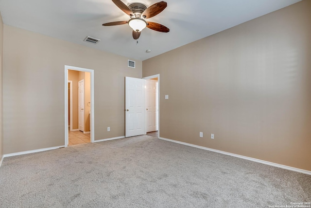 unfurnished bedroom featuring baseboards, visible vents, ceiling fan, and light colored carpet