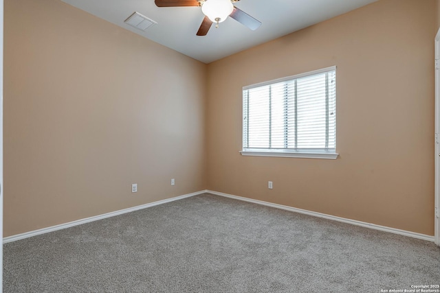 carpeted spare room featuring visible vents, ceiling fan, and baseboards