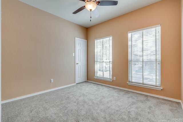 unfurnished room with a ceiling fan, carpet flooring, and baseboards